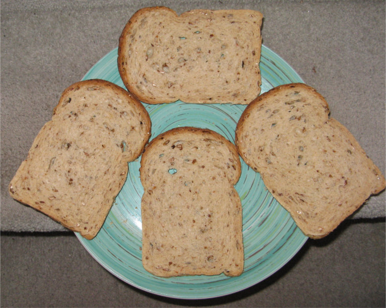Four slices of brown bread on a blue plate