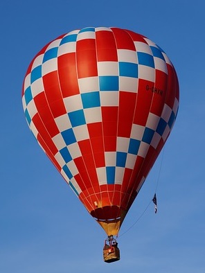 Hot air balloon.Red with blue and white chequered diagonal bands.
