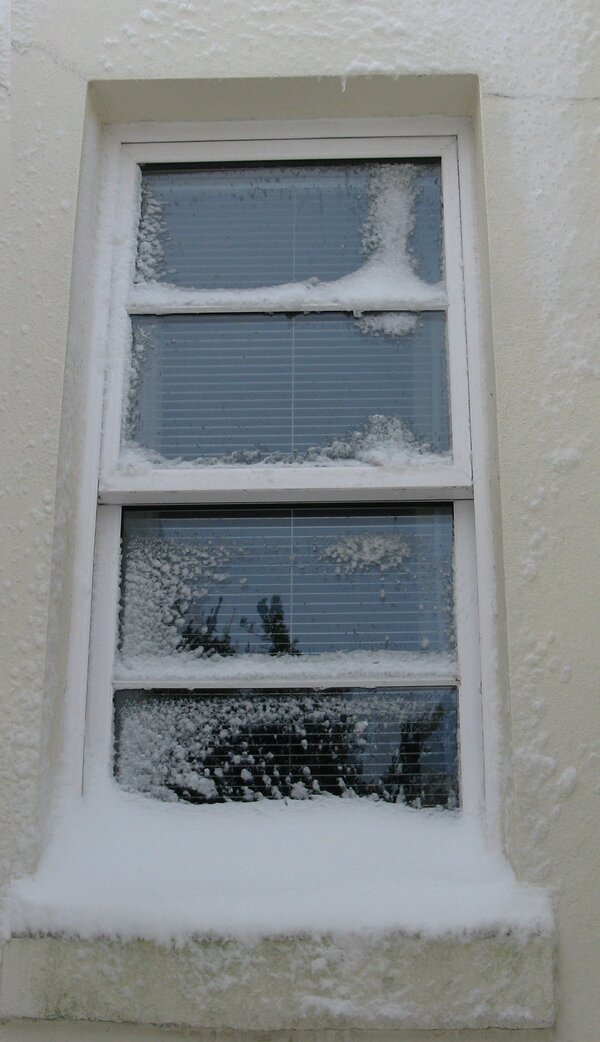 Sah window with snow on glazing bars and sill