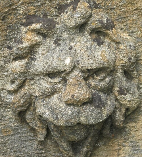 Ornamental round stone lion face