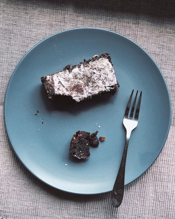 Slice of chocolate cake on blue plate