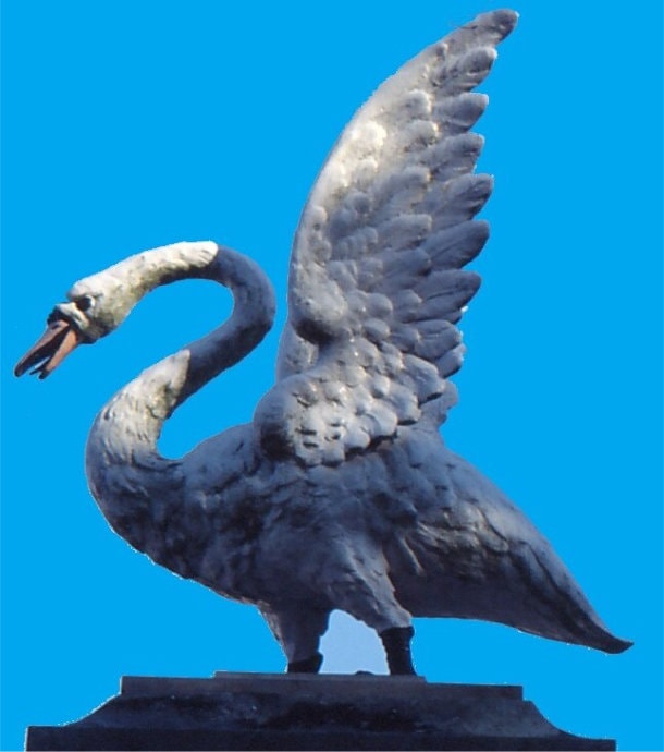 Heraldic swan on gate pillar wings raised neck arched.