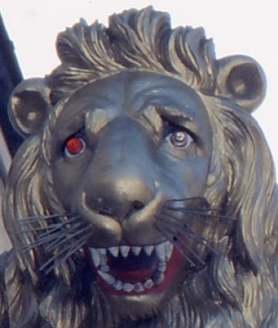 Lion's head carving with one red eye, one normal